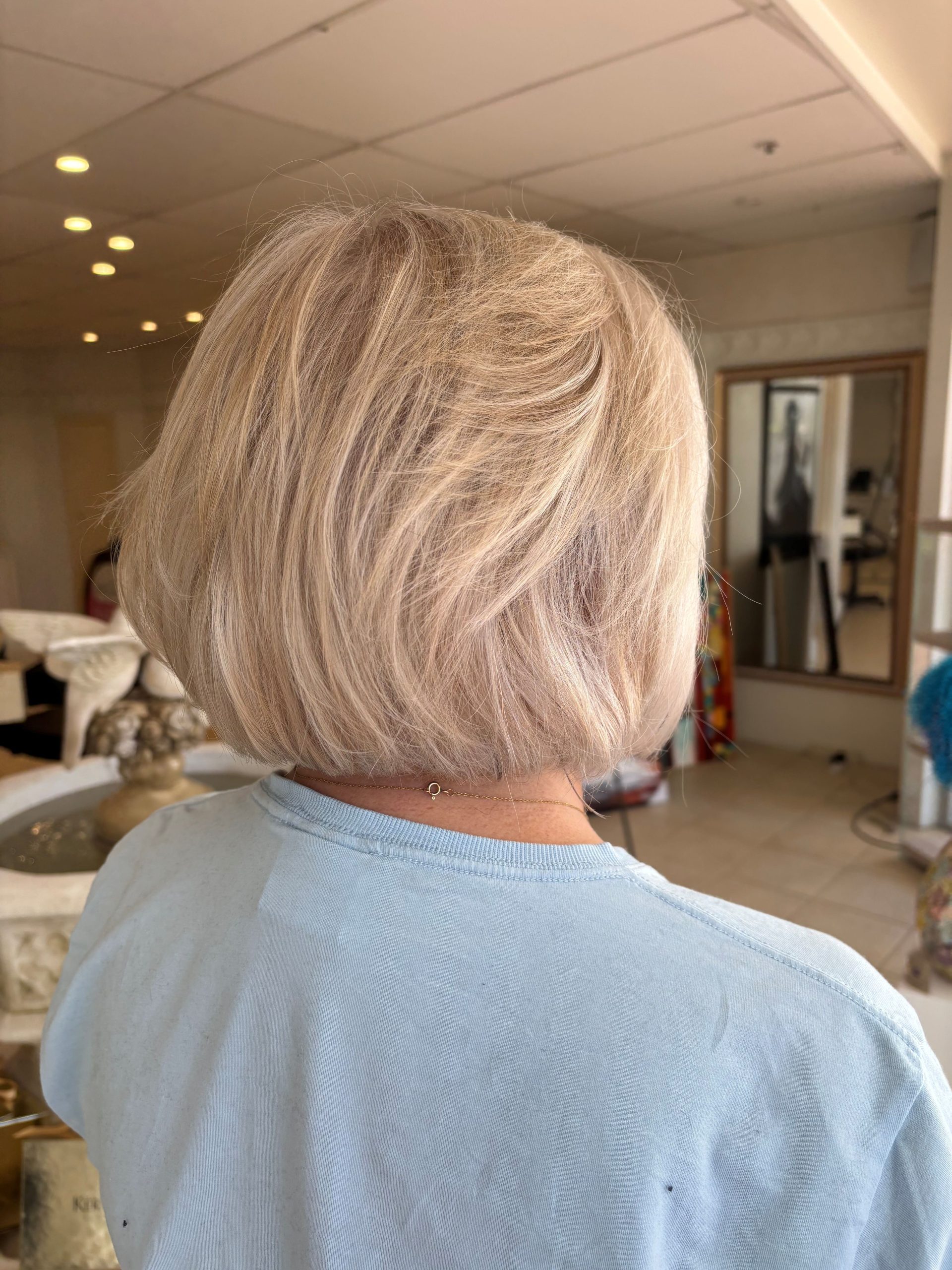 Grey blending highlights soft dimensional blonde bob natural finish at Salon Maggie G